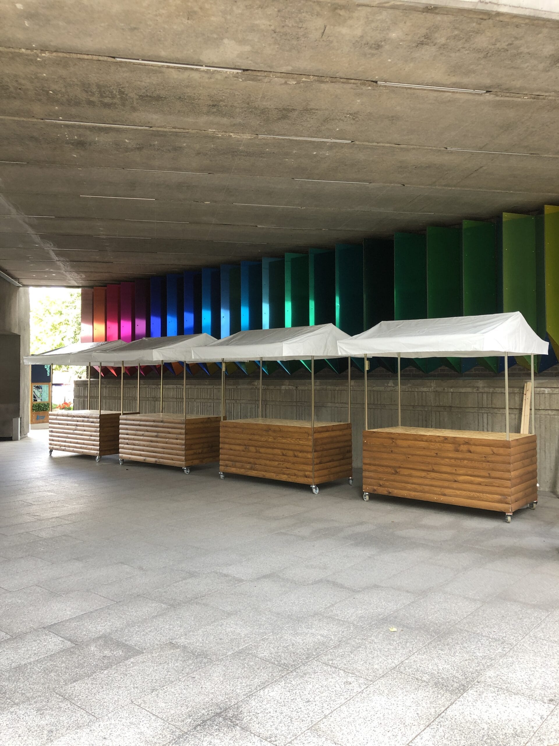 Four empty wooden food carts for hire at big kahuna