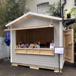 Outdoor Kiosk Selling Drinks Outside of a Pub