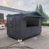 A 4m x 2.3m Kiosk Painted Black With its Front Panel Open