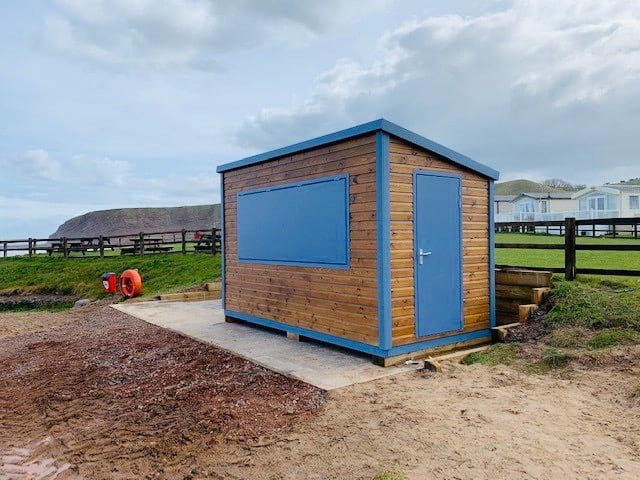 Side Photograph of a Newly Built 4m x 2.4m Wooden Kiosk with Blue Painted Panel and Doors