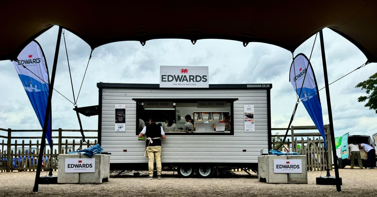 Custom-built food trailer with serving hatch and full wrap branding at outdoor event