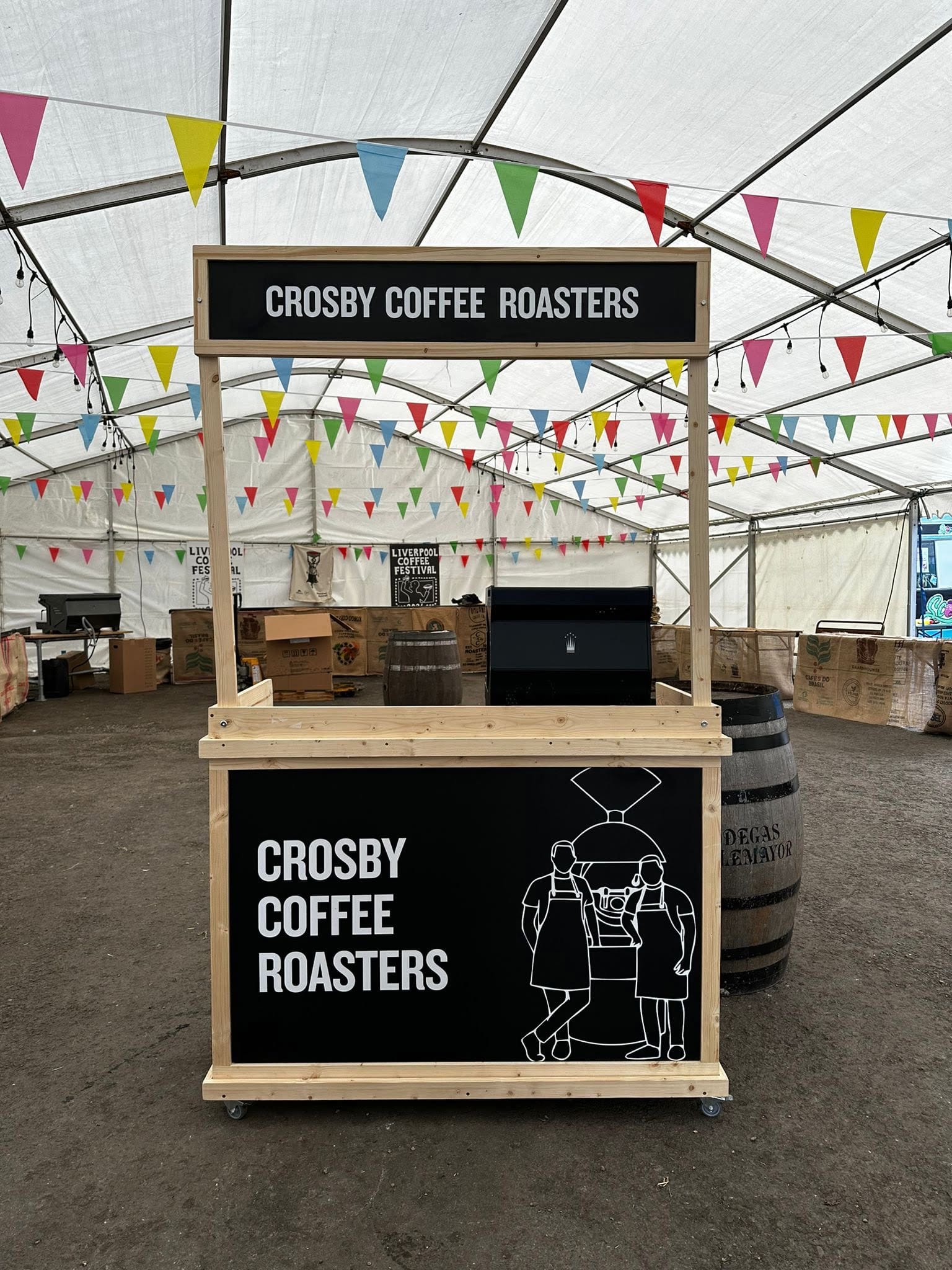 Compact flat-pack coffee cart with wheels and overhead frame, ideal for fast setup at pop-up events