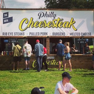 Wooden catering stall with bold overhead signage banner, designed for high-traffic festival and pop-up food events.
