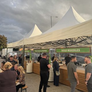 Portable food stall with log lap cladding and PVC roof, used for pop-up markets and product launches.