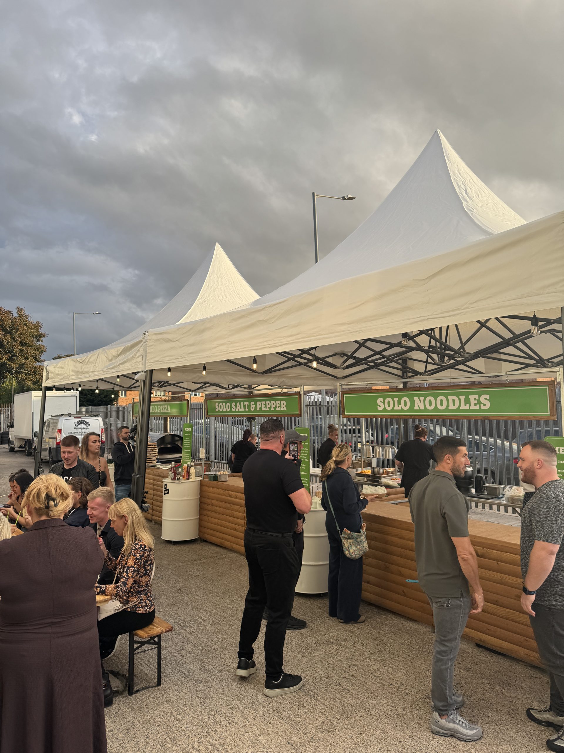 Portable food stall with log lap cladding and PVC roof, used for pop-up markets and product launches.