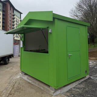 green retail food kiosk with serving hatch