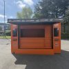 Front view of product sampling kiosk with large customer serving hatch