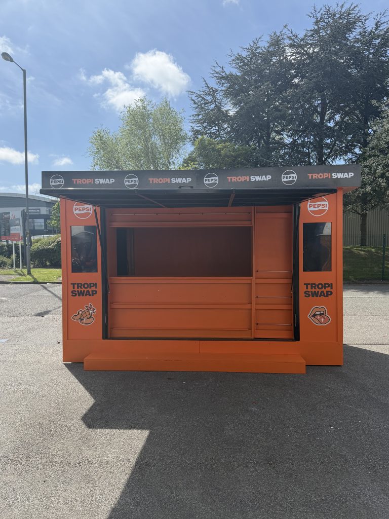 Front view of product sampling kiosk with large customer serving hatch