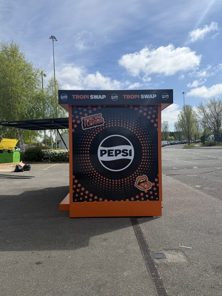 Side view of modular brand activation kiosk with full campaign graphics