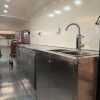 Interior of Citroën HY style mobile bar with stainless steel counter and serving area