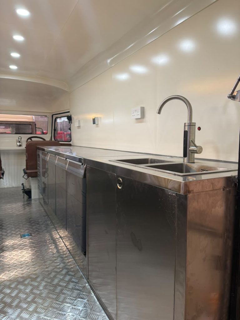 Interior of Citroën HY style mobile bar with stainless steel counter and serving area