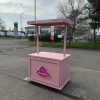 Pink custom branded vendor cart for sale with overhead signage