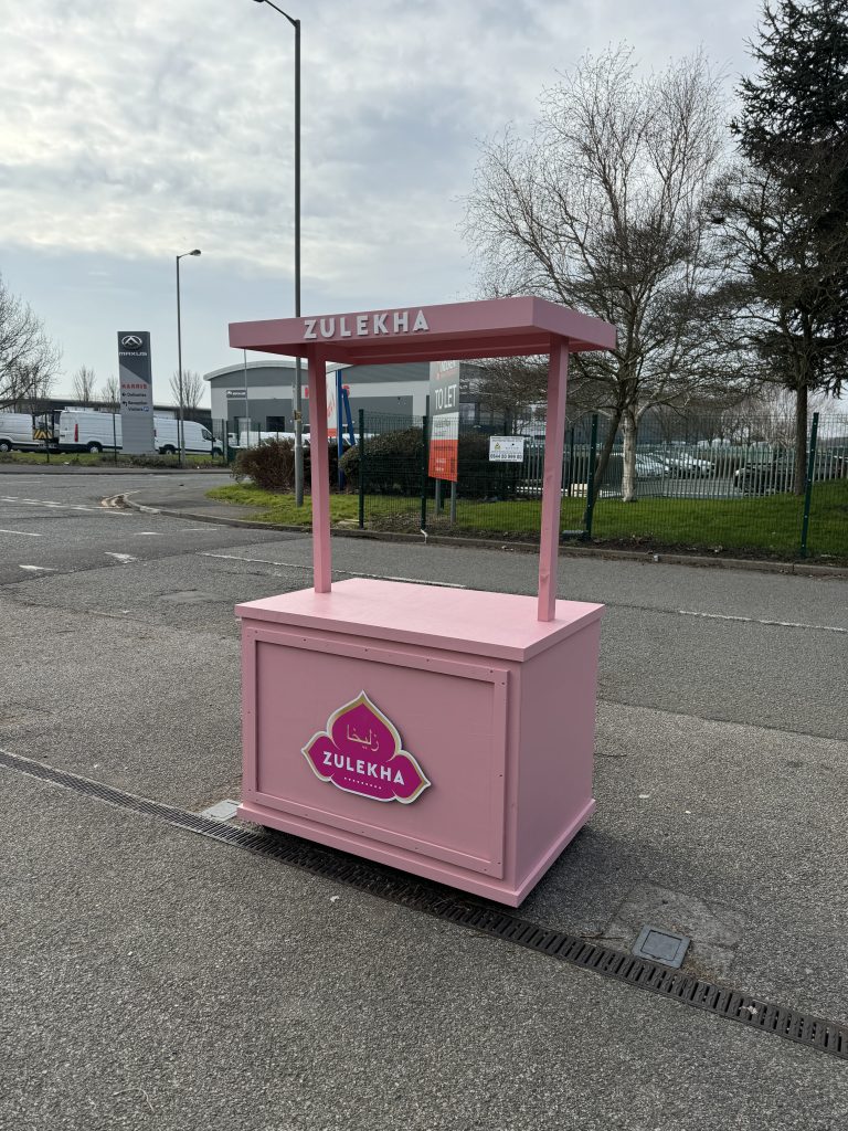 Pink custom branded vendor cart for sale with overhead signage