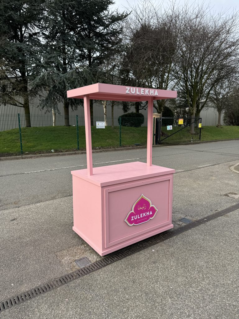 Custom pink flat-pack promotional cart with branded front panel